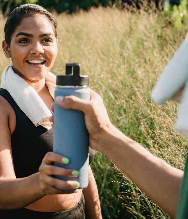 A happy woman smiling and feeling refreshed after a workout.